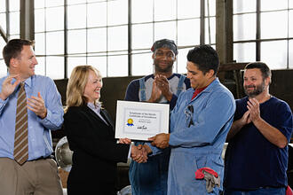 employee_receiving_recogniztion_at_successful_small_business