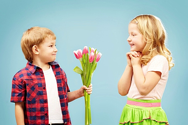 boy giving girl flowers