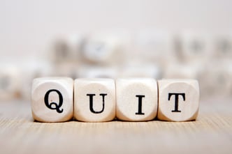 QUIT_spelled_out_on_wooden_dice