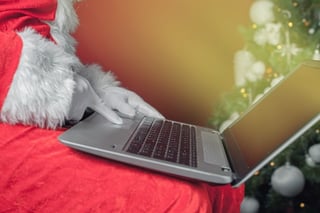 santa_clause_holding_a_laptop