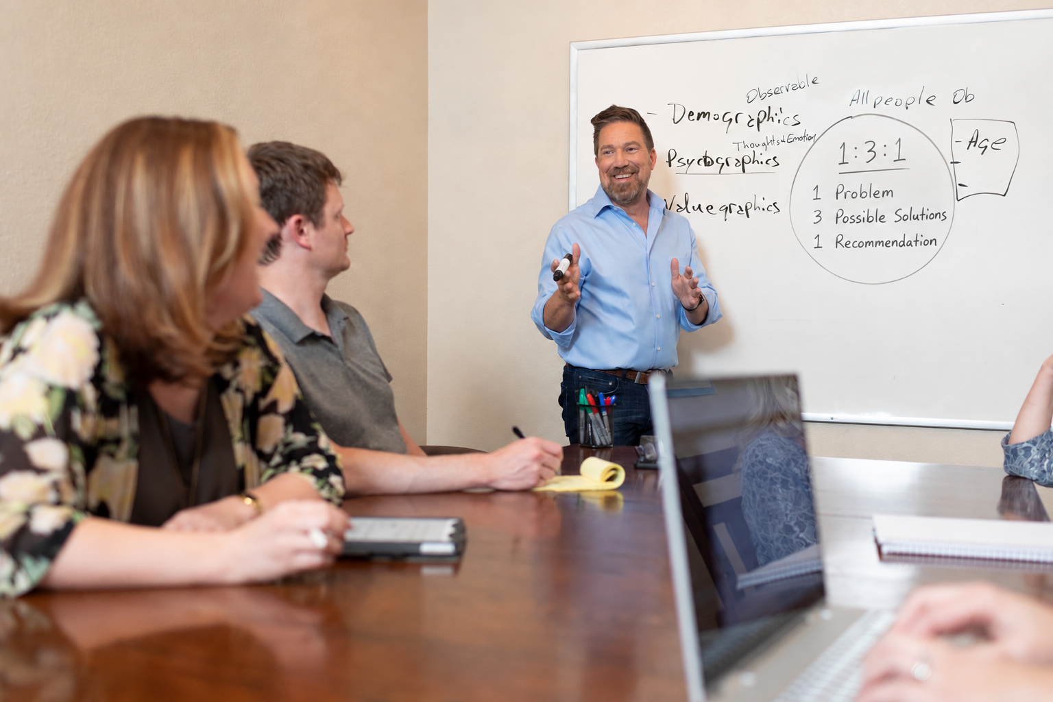 Michael teaching staff in conference room