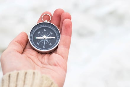 hand holding compass