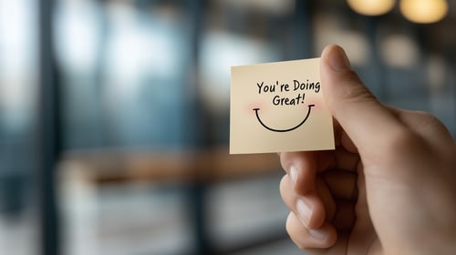 hand holding phrase youre doing great on sticky note
